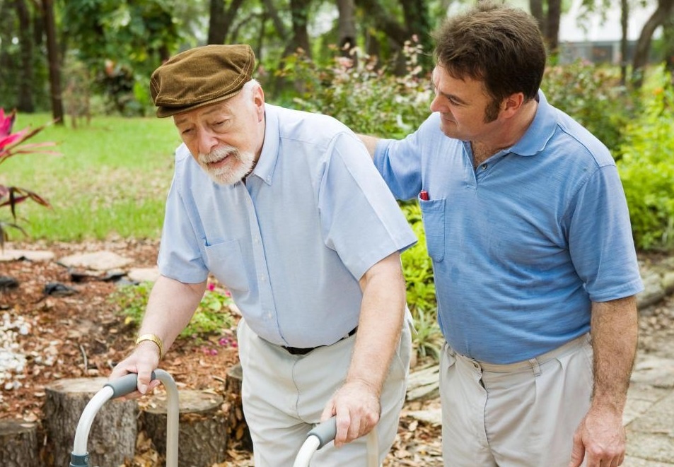 Man in blue shirt with man and walker