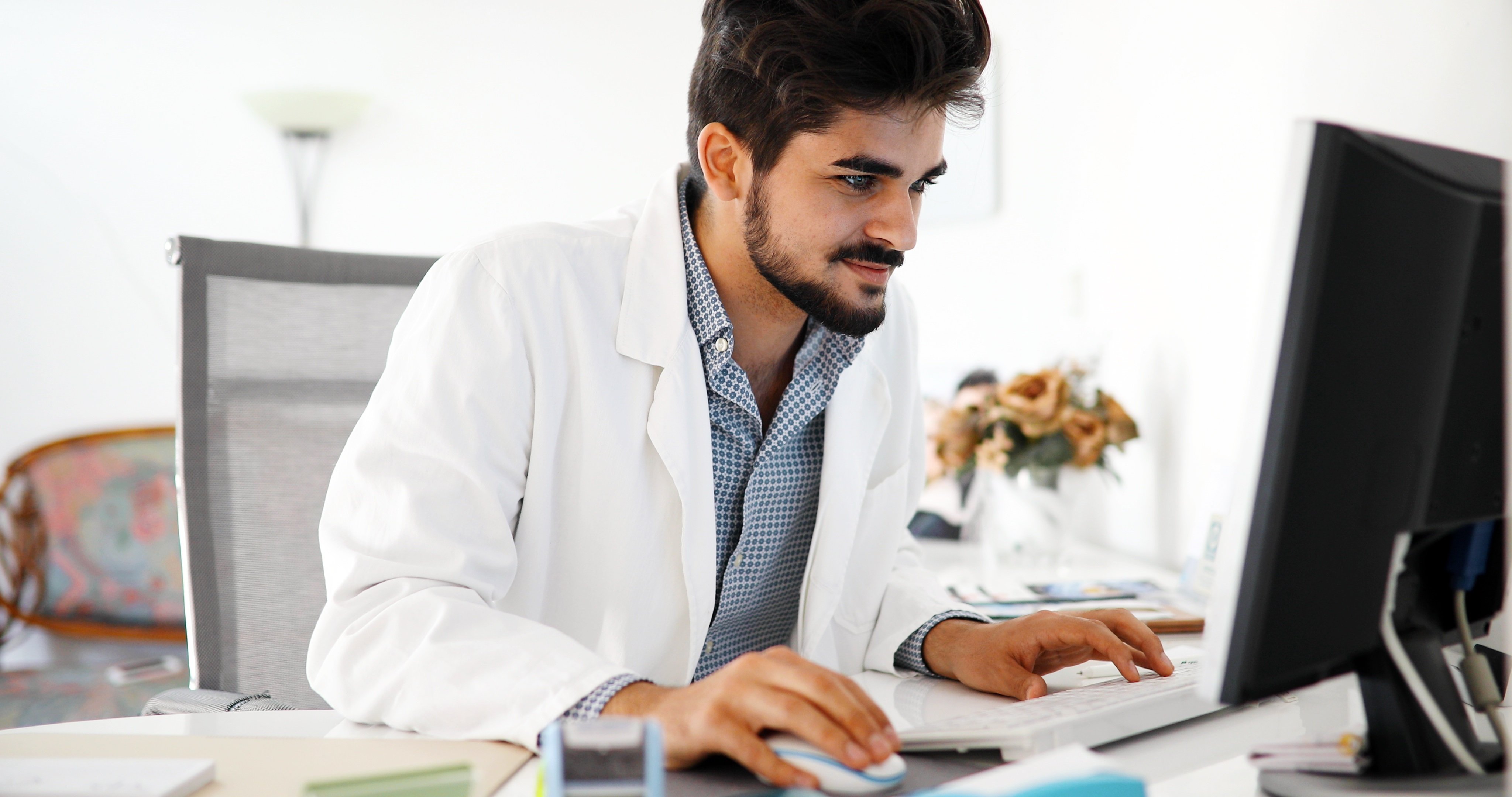 Doctor typing on his computer