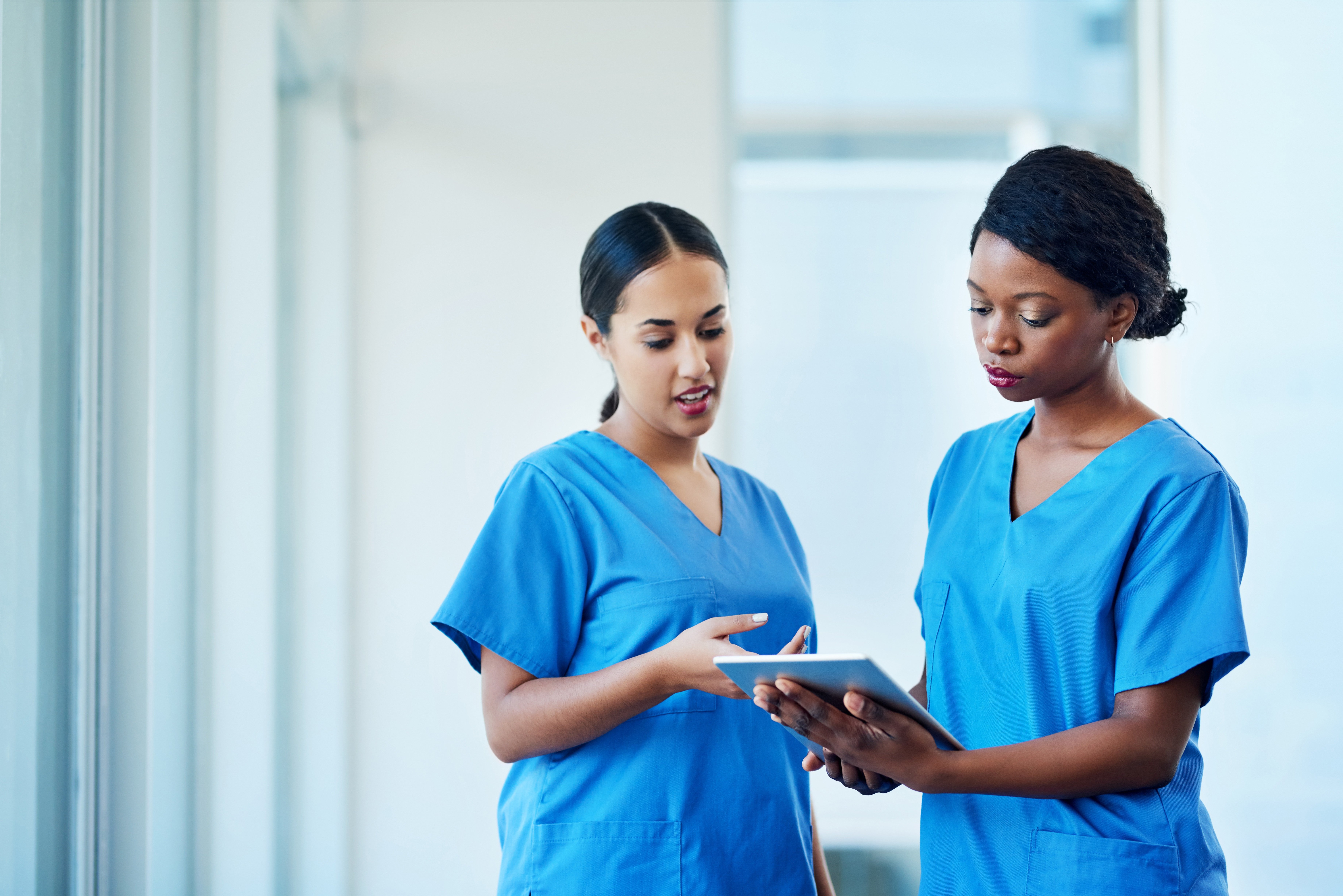 Nurses on tablet working on certification