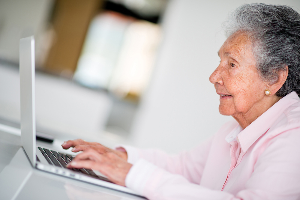 Woman using a computer and looking very happy