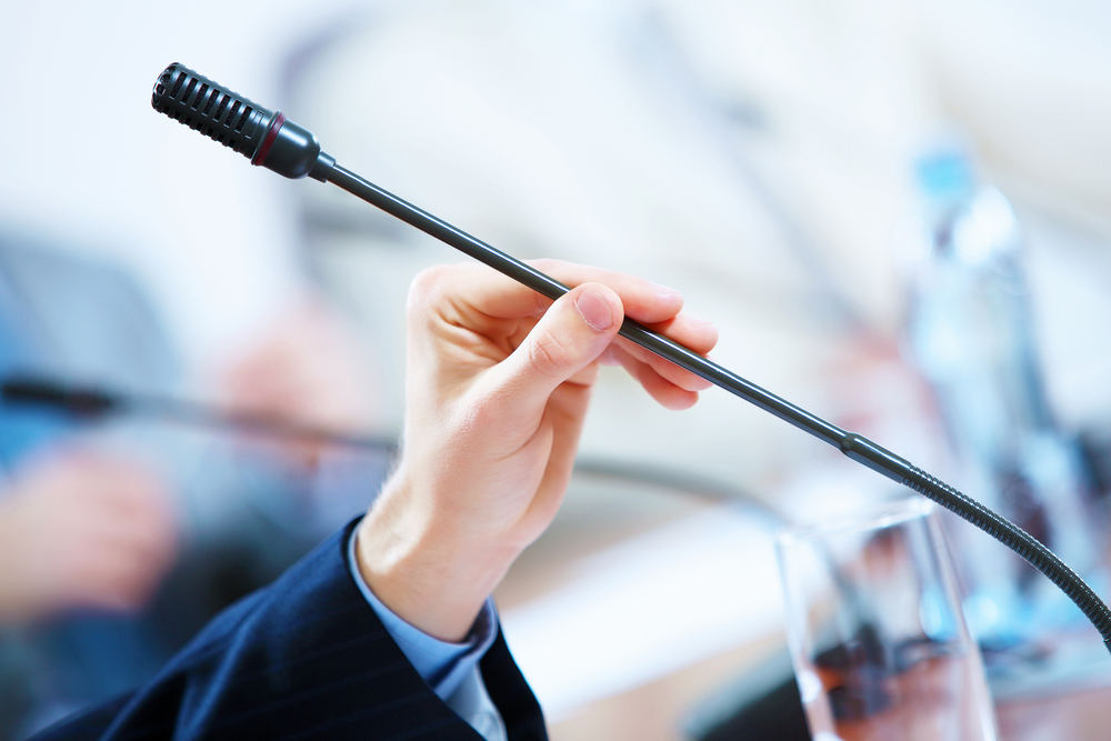 before a conference, the microphones in front of empty chairs