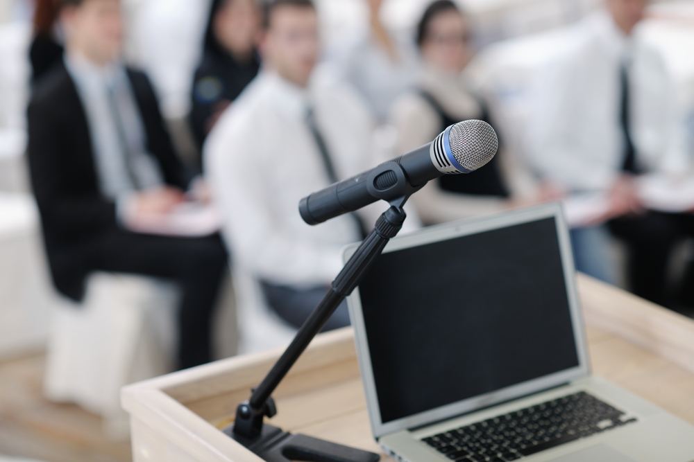 business laptop and microphone at podium on seminar conference education
